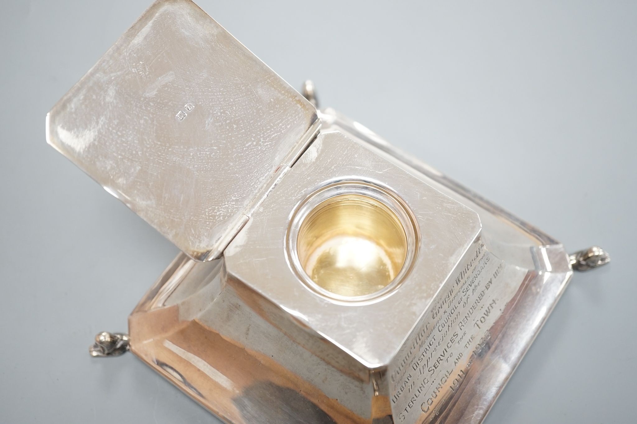 A George V silver mounted inkwell, Birmingham, 1924, with presentation inscription and monogram, 14.2cm.